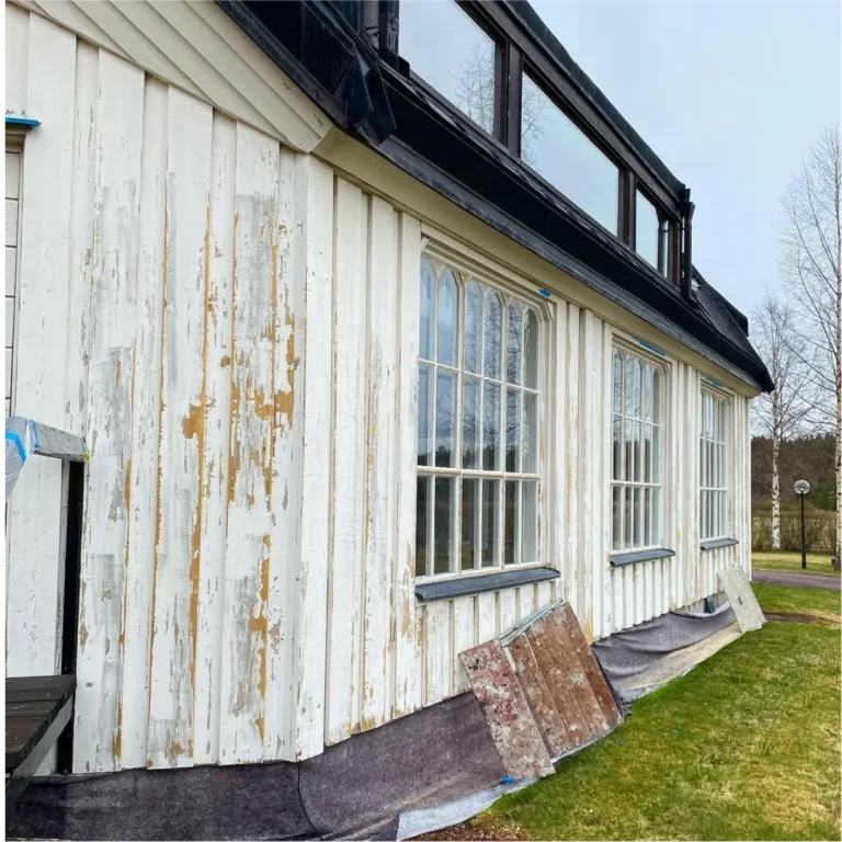 Sliten fasadfärg på långsidan av Yttermalungs kapell före målning